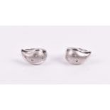 A pair of 18ct white gold and diamond earrings the mount with brushed finish, inset with small