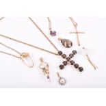 A group of assorted gold gem-set pendants including a smoky quartz cross, a yellow gold cross, a