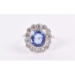 A platinum, diamond, and sapphire ring set with a cushion-cut blue sapphire of approximately 4.0