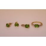 A 14ct yellow gold, diamond, and peridot ring set with an oval-cut peridot, the shoulders set with