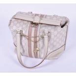 A Gucci cream monogram leather ladies handbag with velvet strip, cream leather handles and trim, the