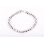 An 18ct white gold and diamond line bracelet set with thirty nine round brilliant-cut diamonds of