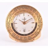 A Hermes world time travel desk clock the face with gilt studs for numerals and dauphine hands,