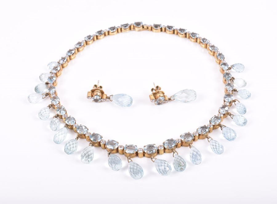 A silver gilt and aquamarine necklace the riviere-style necklace with mixed oval-cut aquamarines