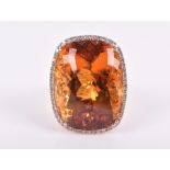 A 14ct yellow gold, diamond, and citrine cocktail ring set with a large faceted orange citrine of