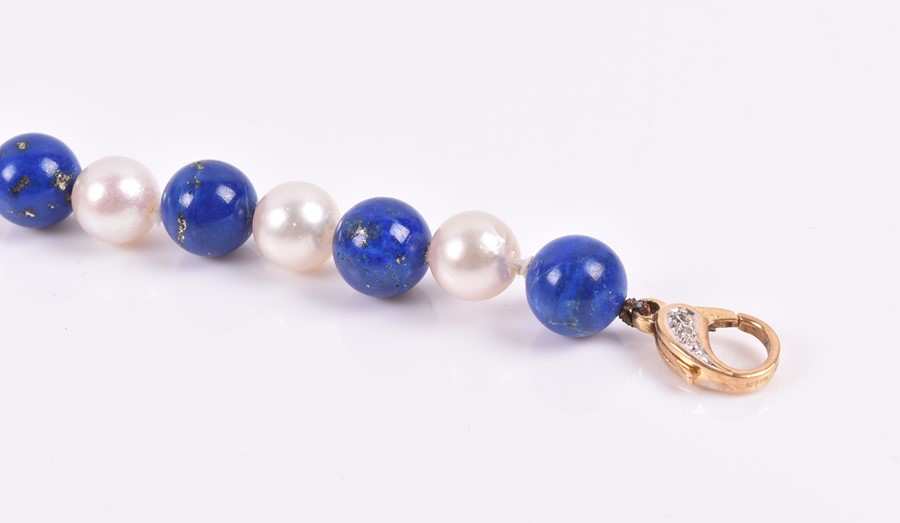 A lapis lazuli and pearl bracelet of alternated beads, fastened with an 18ct yellow gold and - Image 2 of 2