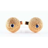 A pair of 18ct yellow gold cufflinks by Kutchinsky,  of domed textured form, each set with a small