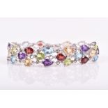 A silver and multi-gem bracelet set with amethyst, garnet, citrine, peridot, and blue topaz, 19 cm