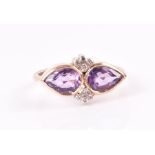 A 9ct yellow gold, amethyst and diamond ring set with two pear-cut amethysts, and two diamond accent