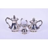 A German silver three piece associated tea set comprising a coffee pot, a tea pot and a cream jug,