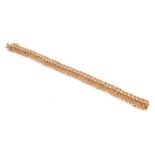 An 18ct yellow gold and diamond bracelet of articulated form, set with forty three round brilliant-