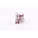 An 18ct white gold, diamond, and ruby cluster ring set with twelve round-cut diamonds and five