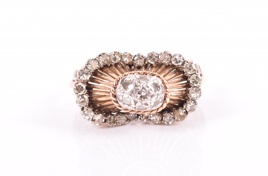 An unusual rose gold and diamond ring with ornate domed mount inset with old-cut diamonds, the mount