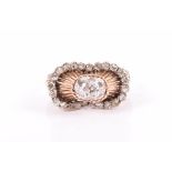 An unusual rose gold and diamond ring with ornate domed mount inset with old-cut diamonds, the mount