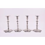 A good set of George III silver candlesticks London, 1750 by John Cafe, with scalloped bases