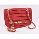 Moschino vinyl handbag in orange red the vinyl folded design is adorned with the Moschino logo