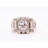 An Art Deco style diamond ring set with a round brilliant-cut diamond of approximately 1.20