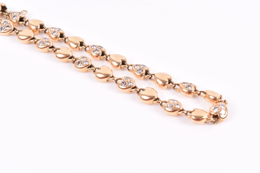 Cartier. An 18ct yellow gold and diamond bracelet with heart-shaped links, each set with three round - Image 3 of 4