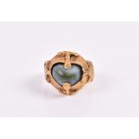 An Antique yellow gold and turquoise ring possibly Islamic, loosely set to heart-shaped centre