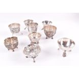 A collection of eight Dutch silver sugar bowls to include five with embossed foliage cartouches