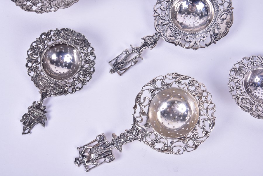 A collection of ten 20th century Dutch tea strainers each with pierced floral rims with pastoral - Image 5 of 5