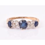 An 18ct yellow gold, diamond, and sapphire ring set with three sapphires and two old-round cut