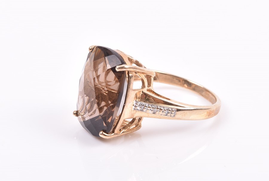 A 9ct yellow gold and smoky quartz ring set with a top-faceted rectangular-cut quartz, the shoulders - Image 3 of 3