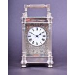 A solid silver carriage clock by Charles Frodsham hallmarked London 1977, the white enamel dial with