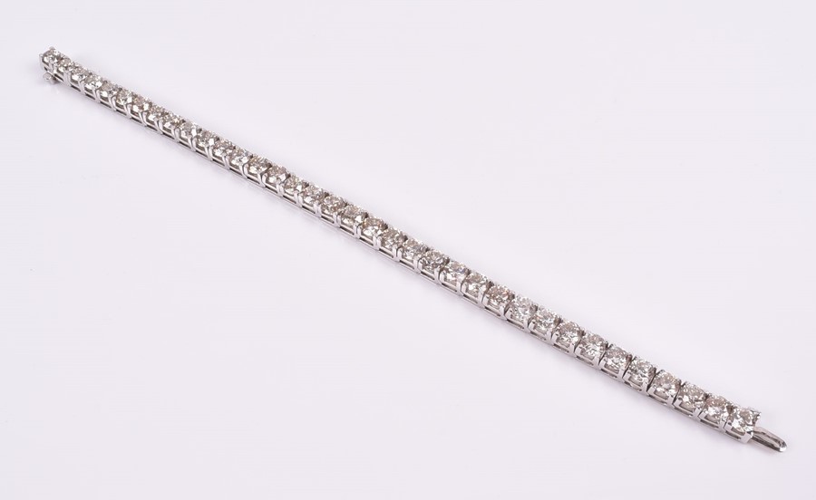 An impressive diamond line bracelet set with thirty six round-cut diamonds, of approximately 21.0