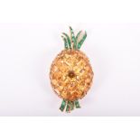 A citrine and emerald brooch in the form of a pineapple set with faceted square-cut deep yellow