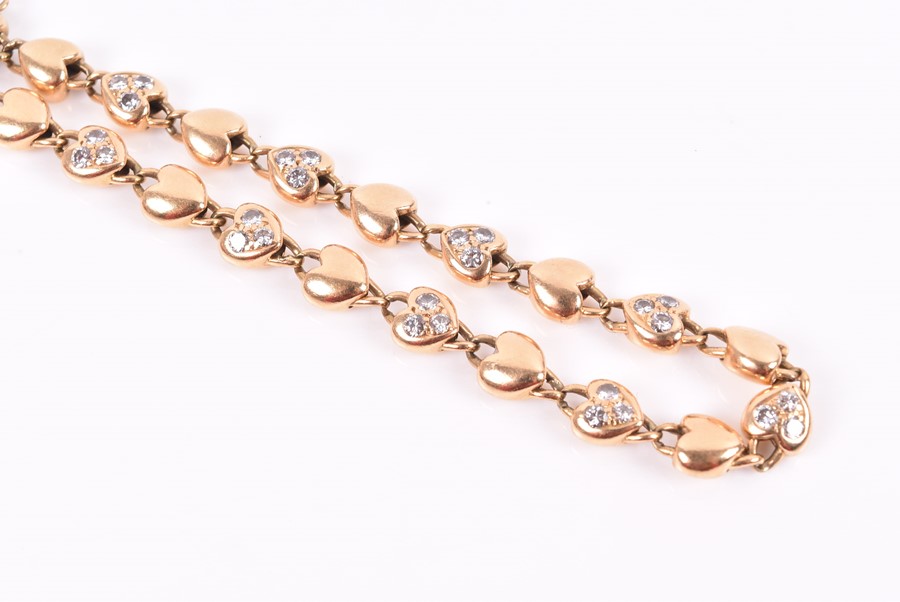 Cartier. An 18ct yellow gold and diamond bracelet with heart-shaped links, each set with three round - Image 4 of 4