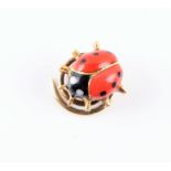 Cartier. A yellow gold and enamel ladybird pin with red wings and black spots, spiral to reverse for