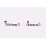 A pair of diamond and pearl drop earrings the articulated line mounts with individually set round-