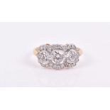 An 18ct yellow gold and diamond triple cluster ring set with three round-cut diamonds within a