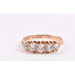 An 18ct yellow gold and diamond ring set with five graduated old-cut diamonds of approximately 0.