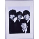 A large 1966 framed photo of the Beatles in black and white, within a glazed frame with white