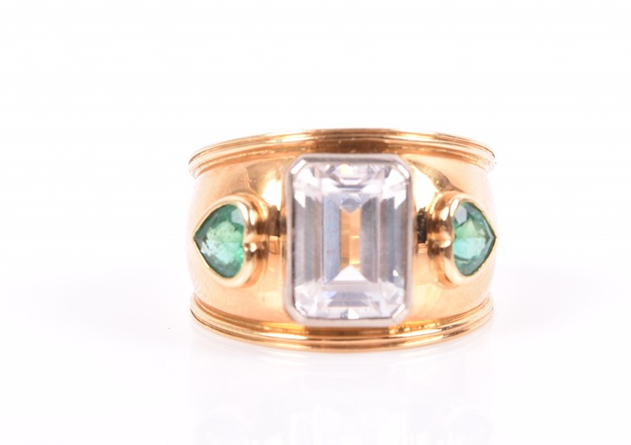 Theo Fennell. An 18ct yellow gold, emerald, and cubic zirconia ring the wide band centred with an