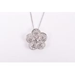 An 18ct white gold and diamond floral pendant set with six rose-cut diamonds surrounded with five