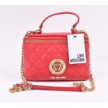 Love Moschino bag in red the quilted leather body is adorned with a gold tone metal Love Mochino