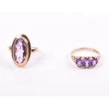 A 9ct yellow gold and amethyst ring set with an elongated oval-cut amethyst within a gold border,