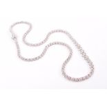 An 18ct white gold and diamond line necklace individually claw-set round brilliant-cut diamonds of