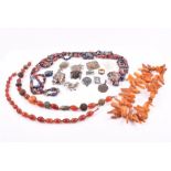 A group of various amber and other beaded necklaces together with twenty four various brooches and