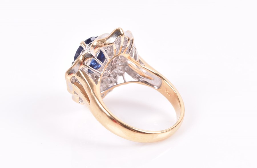 An 18ct yellow gold, diamond, and sapphire ring set with an oval-cut sapphire, within two double - Image 2 of 3