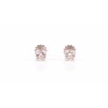 A pair of solitaire diamond ear studs set with round brilliant-cut diamonds of approximately 0.80