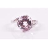 An 18ct white gold and kunzite ring set with an unusual faceted round-cut kunzite of approximately