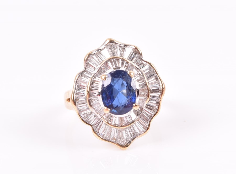 An 18ct yellow gold, diamond, and sapphire ring set with an oval-cut sapphire, within two double