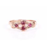 A 9ct yellow gold, ruby, and pearl ring in the antique style, size O, 1.3 grams.