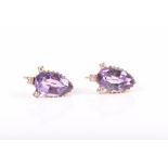 A pair of diamond and amethyst earrings each with a faceted pear-cut amethyst surmounted with