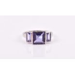 A 9ct white gold and iolite ring set with a square-cut iolite flanked with two baguette-cut iolites,