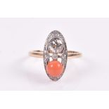 An 18ct yellow gold, diamond, and coral ring the elongated oval mount centred to one side with an